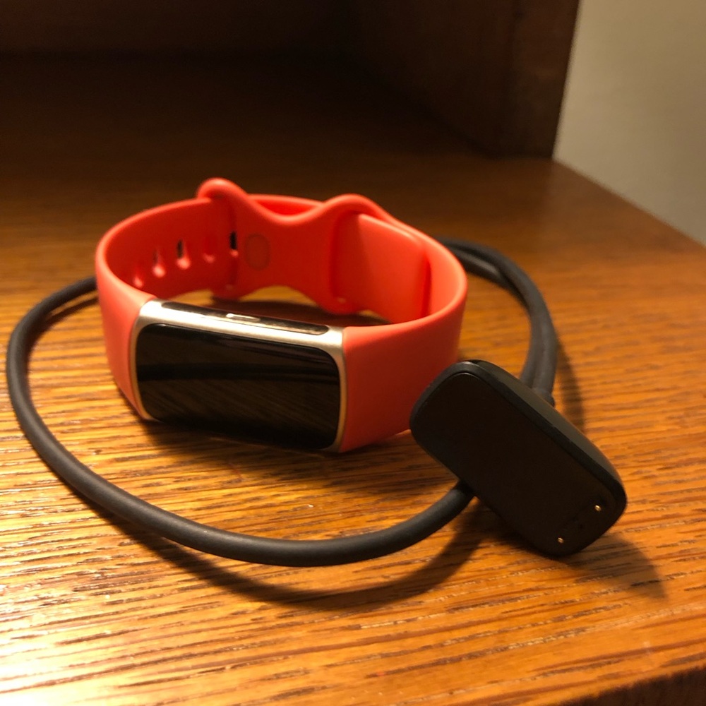 Fitbit Smartwatch with Coral Band and Black Display